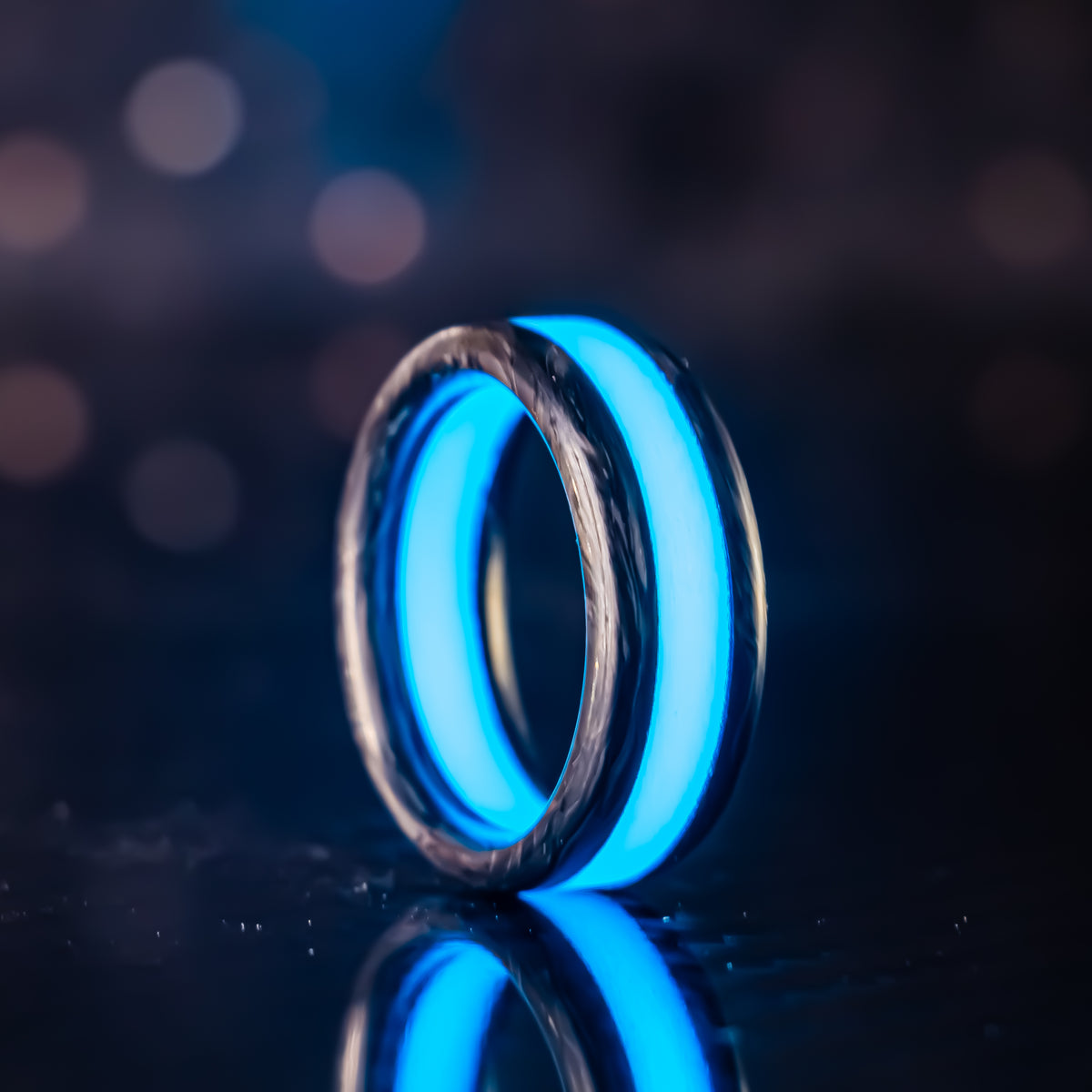 Cobalt Racer wedding band in forged carbon with a blue luminous center stripe