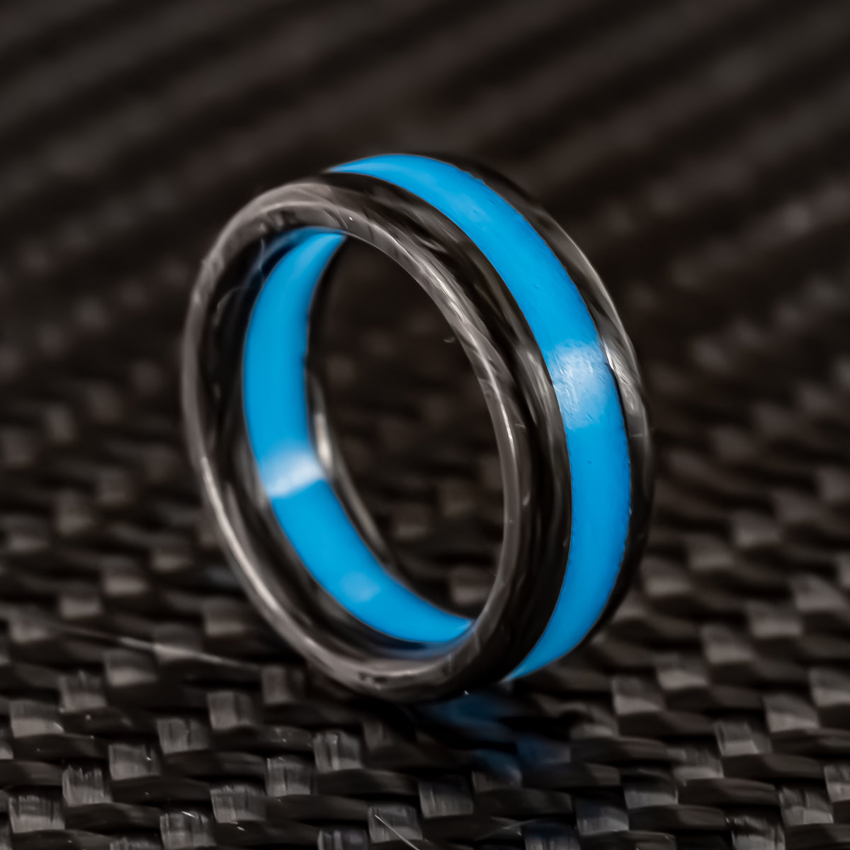 Cobalt Racer wedding band in forged carbon with a blue luminous center stripe