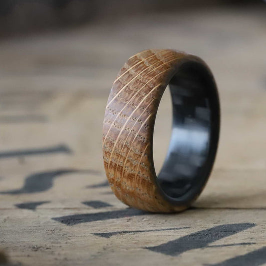 whiskey barrel ring with carbon fiber sleeve on a whiskey barrel lid